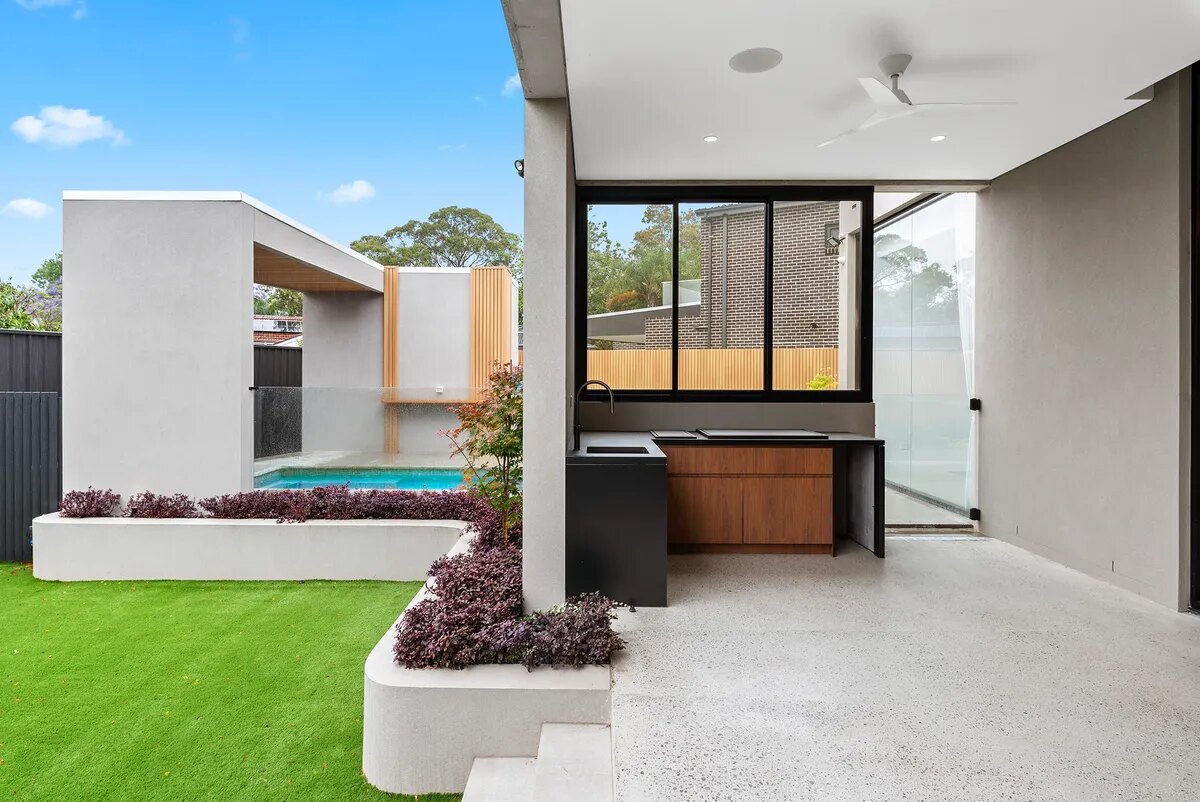 Courtyard pool beside a covered outdoor entertaining area